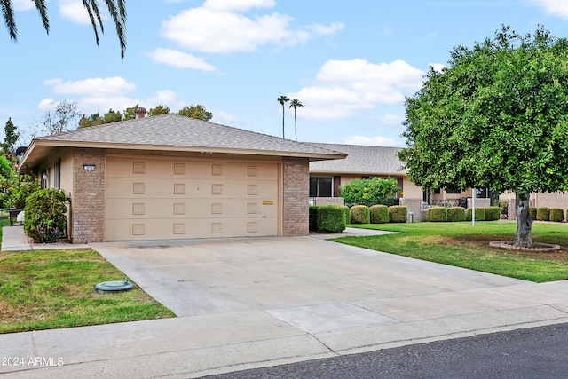 ranch-style home with a garage and a front yard