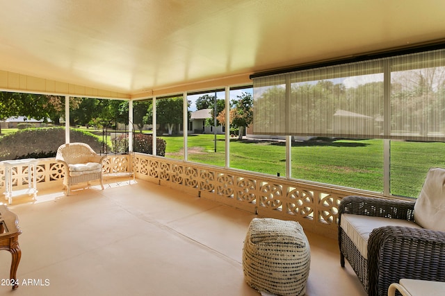 sunroom featuring vaulted ceiling and a wealth of natural light