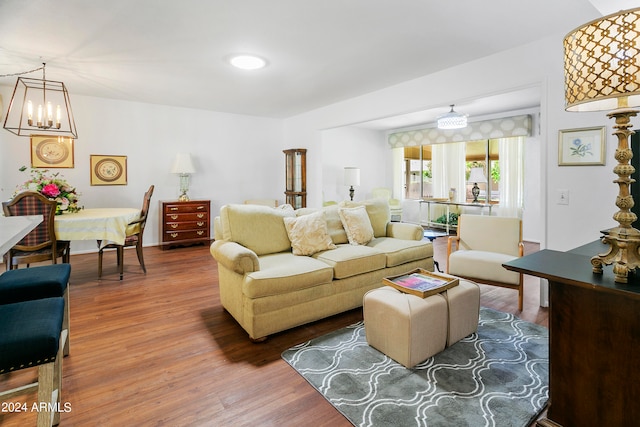 living room with wood-type flooring and an inviting chandelier