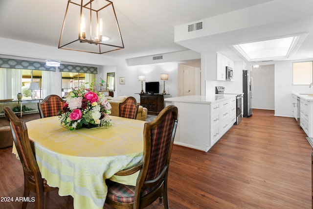 dining room with a notable chandelier and dark wood-type flooring