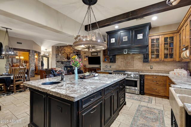 21230 S 156th St, Gilbert, AZ 85298 - kitchen with stainless steel stove, a sink, stone tile floors, dark cabinetry, and beam ceiling