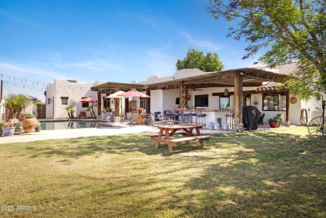 21230 S 156th St, Gilbert, AZ 85298 - back of house featuring a lawn, a patio area, stucco siding, and an outdoor pool