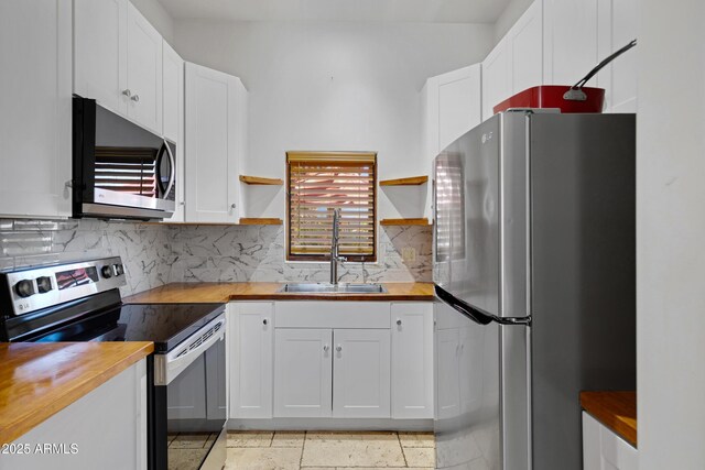 21230 S 156th St, Gilbert, AZ 85298 - kitchen featuring appliances with stainless steel finishes, open shelves, wooden counters, and a sink