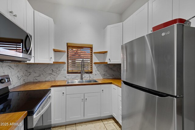 21230 S 156th St, Gilbert, AZ 85298 - kitchen featuring stainless steel appliances, open shelves, wood counters, a sink, and white cabinets
