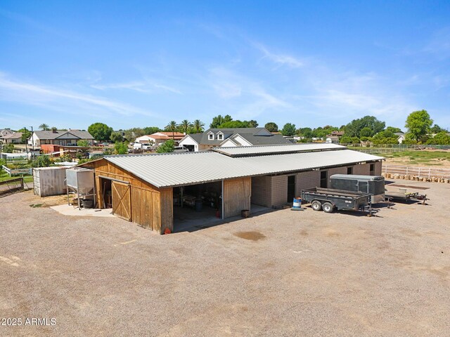 21230 S 156th St, Gilbert, AZ 85298 - view of outbuilding featuring an exterior structure, a residential view, and dirt driveway