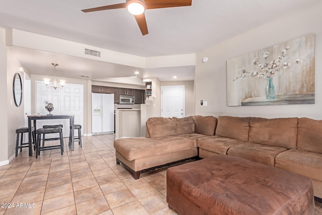 tiled living room featuring ceiling fan with notable chandelier