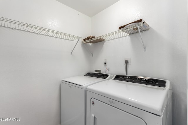 clothes washing area with washing machine and clothes dryer