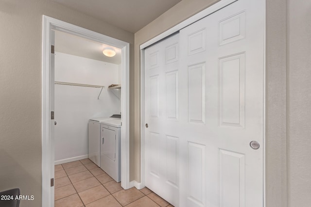 washroom featuring washer and dryer and light tile patterned flooring