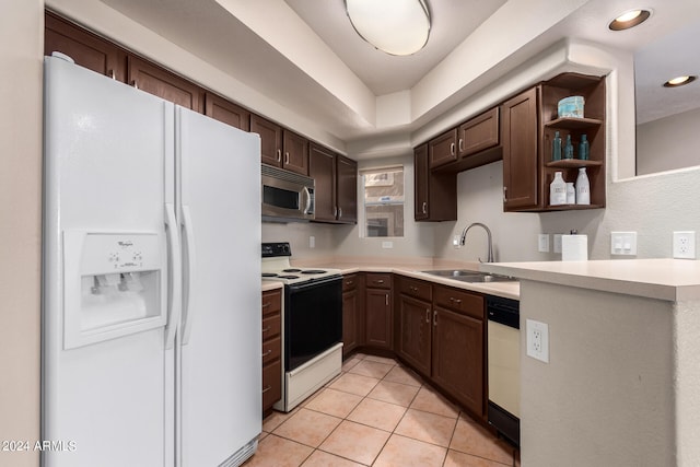 kitchen featuring dark brown cabinets, sink, light tile patterned floors, and white appliances