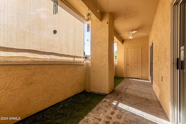 view of exterior entry featuring ceiling fan