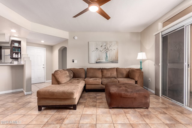 tiled living room featuring ceiling fan