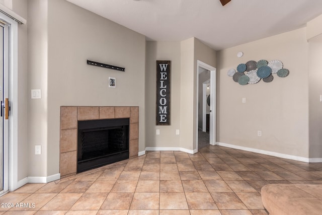 unfurnished living room featuring a fireplace and light tile patterned floors