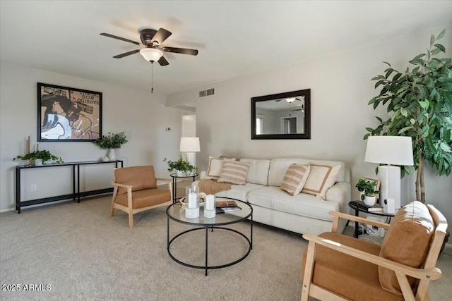 carpeted living room with ceiling fan