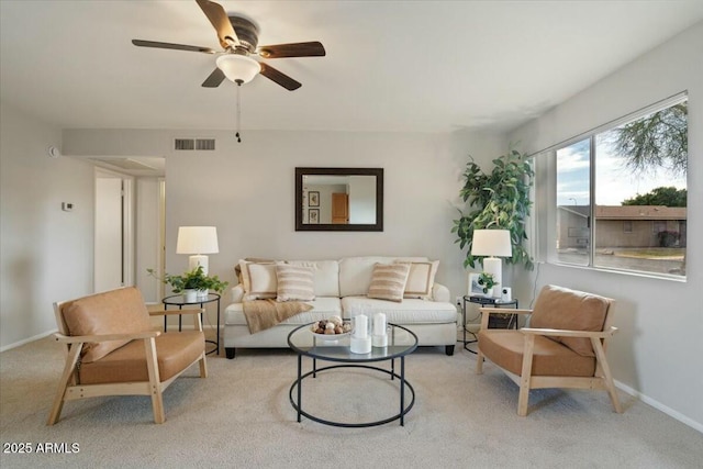 carpeted living room with ceiling fan