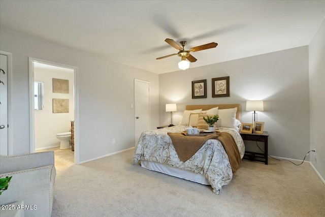 carpeted bedroom featuring ceiling fan and ensuite bath