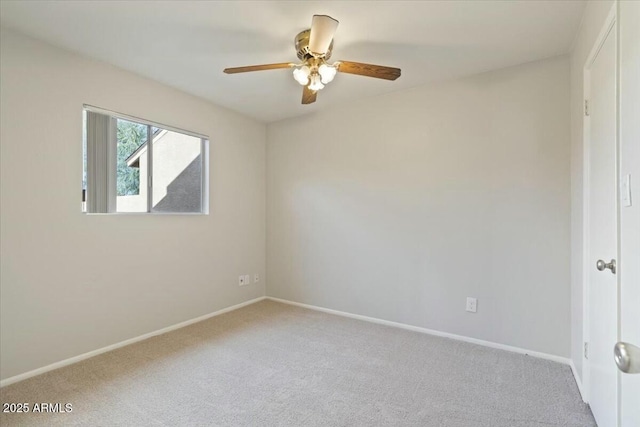 spare room with ceiling fan and carpet