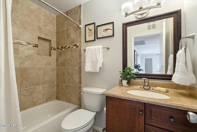 full bathroom with vanity, shower / tub combo, and toilet