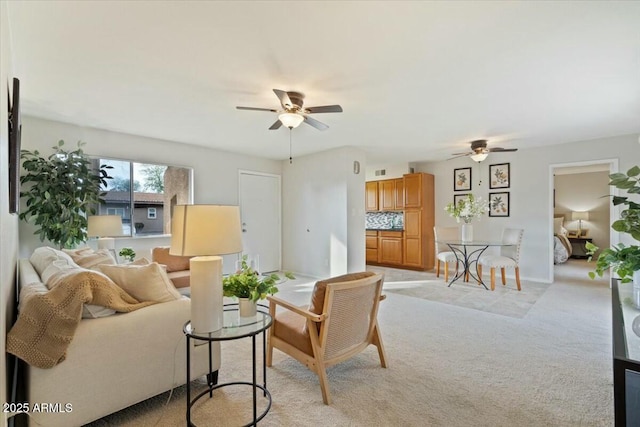 living room with ceiling fan and light colored carpet