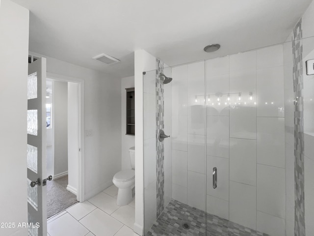 bathroom featuring an enclosed shower, tile patterned floors, and toilet