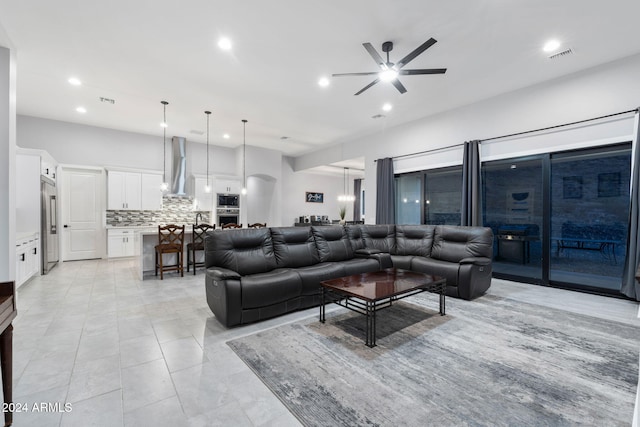 tiled living room with ceiling fan