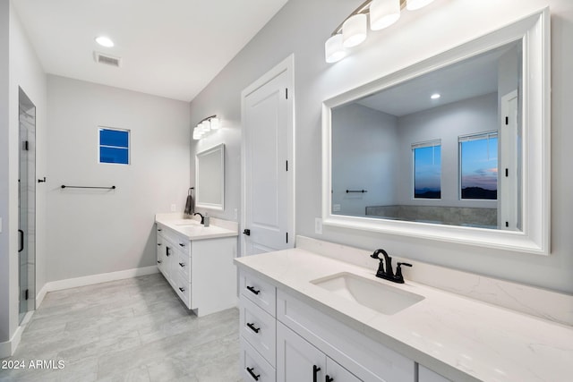 bathroom featuring an enclosed shower and vanity