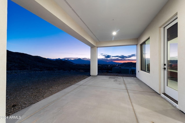 patio terrace at dusk with a mountain view