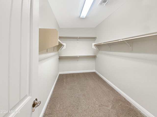 walk in closet featuring carpet