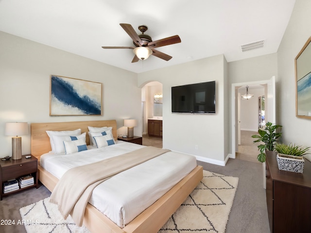 carpeted bedroom featuring connected bathroom and ceiling fan