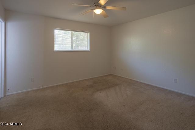 empty room with ceiling fan and carpet