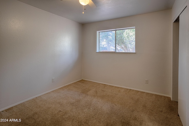 carpeted empty room with ceiling fan