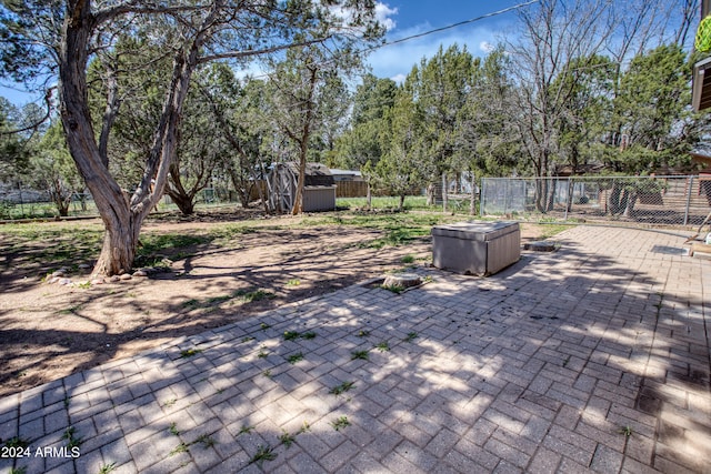 view of patio with a storage shed