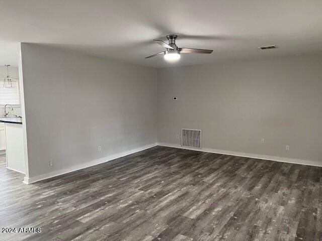 spare room featuring sink, ceiling fan, and dark hardwood / wood-style floors