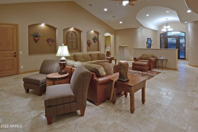 living room featuring ceiling fan with notable chandelier and high vaulted ceiling