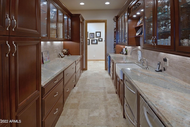 bar with decorative backsplash, dishwasher, light stone countertops, and sink