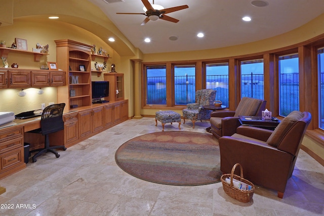 interior space featuring built in desk, ceiling fan, and lofted ceiling