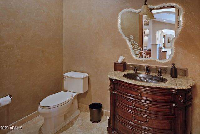 bathroom featuring tile patterned flooring, vanity, and toilet