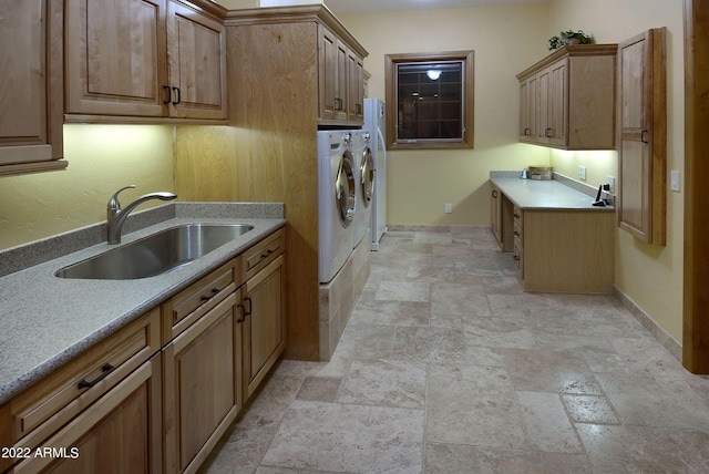 laundry room with cabinets, separate washer and dryer, and sink