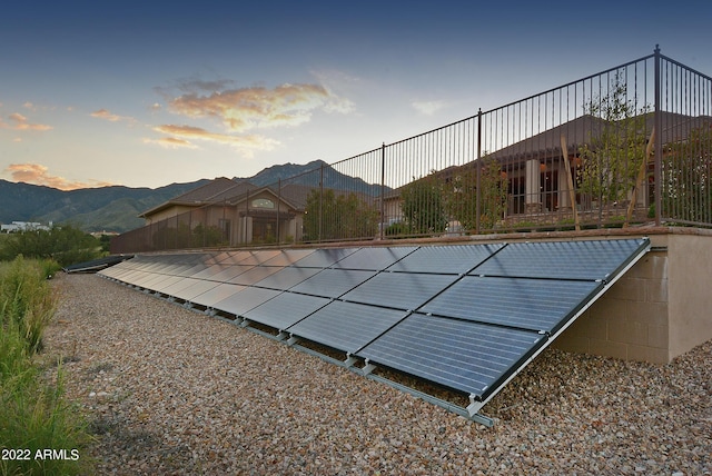 pool at dusk featuring a mountain view