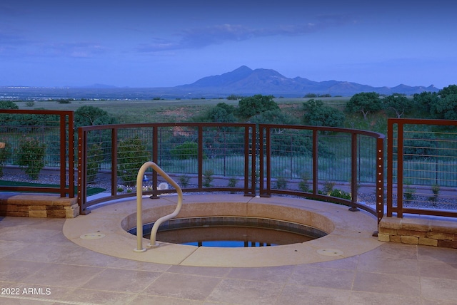 view of swimming pool with a mountain view and a jacuzzi