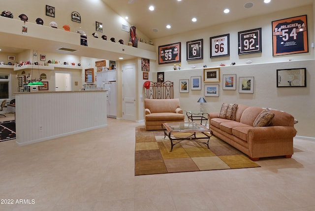 living room featuring light tile patterned floors and high vaulted ceiling