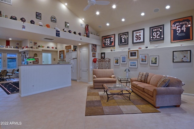 tiled living room featuring ceiling fan and high vaulted ceiling