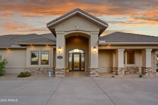 view of exterior entry at dusk