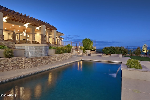 pool at dusk with a patio area