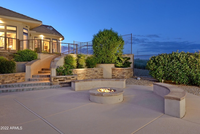 patio terrace at dusk with an outdoor fire pit