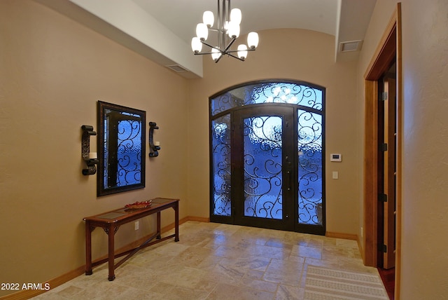 entryway featuring french doors and an inviting chandelier