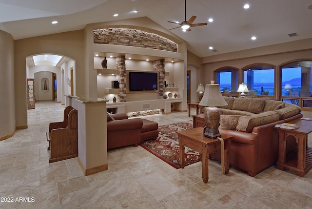 living room featuring ceiling fan and high vaulted ceiling