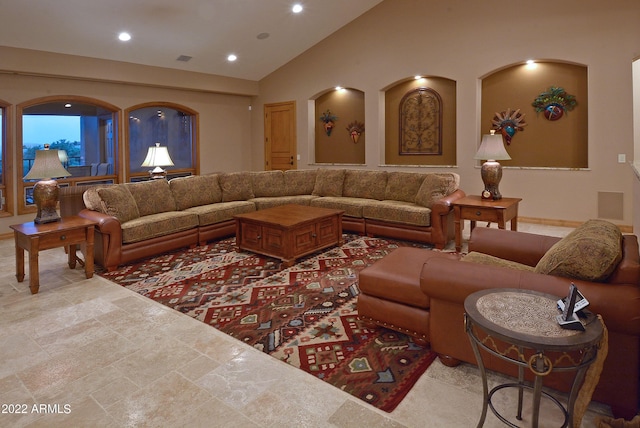 living room with high vaulted ceiling