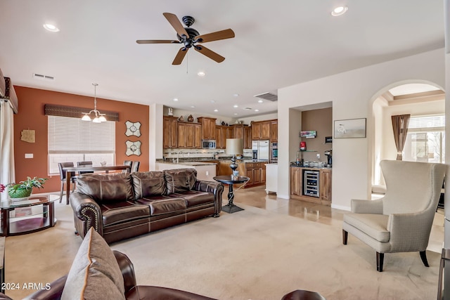 3660 S Golden Eye Ln, Gold Canyon, AZ 85118 - living area featuring arched walkways, ceiling fan, visible vents, and beverage cooler