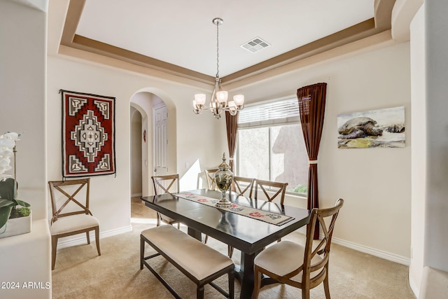 3660 S Golden Eye Ln, Gold Canyon, AZ 85118 - dining room featuring light carpet, visible vents, arched walkways, and a raised ceiling