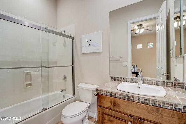 3660 S Golden Eye Ln, Gold Canyon, AZ 85118 - bathroom with combined bath / shower with glass door, toilet, vanity, a ceiling fan, and decorative backsplash